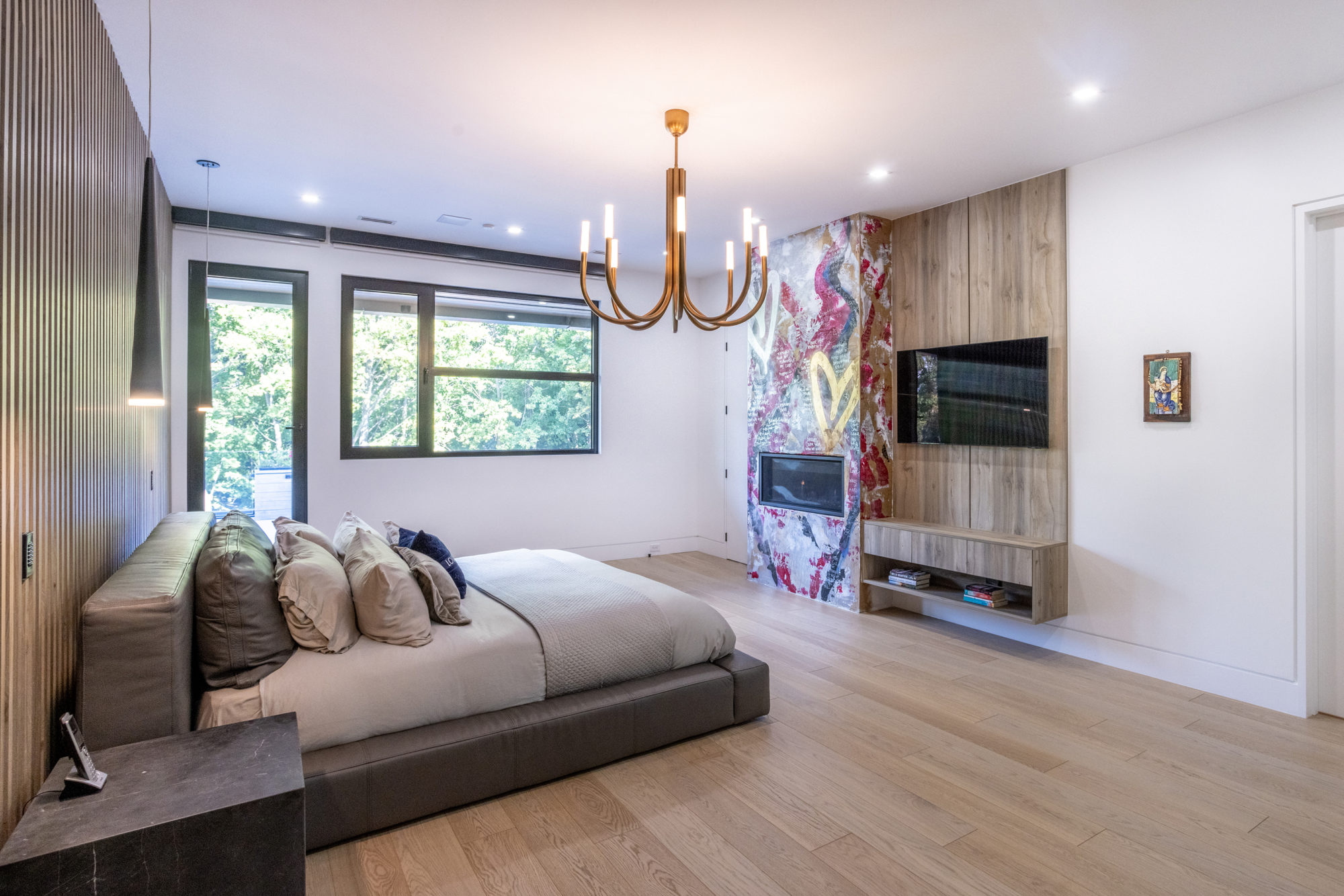 The main bedroom custom with a hand-painted mural surrounding the fireplace. 