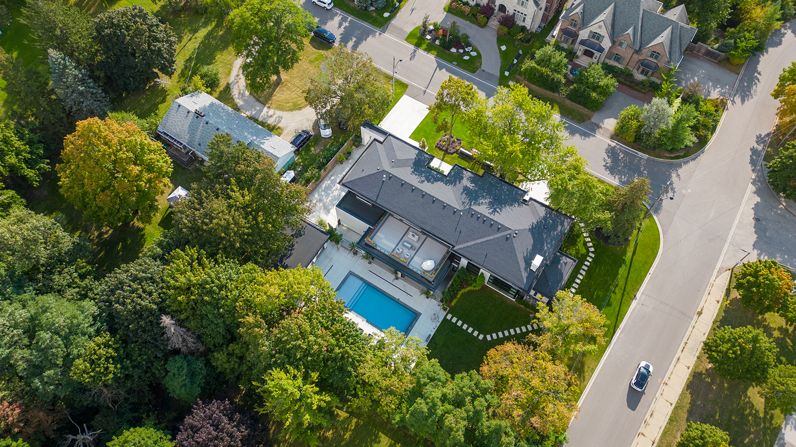 Mature trees dot the verdant property. 