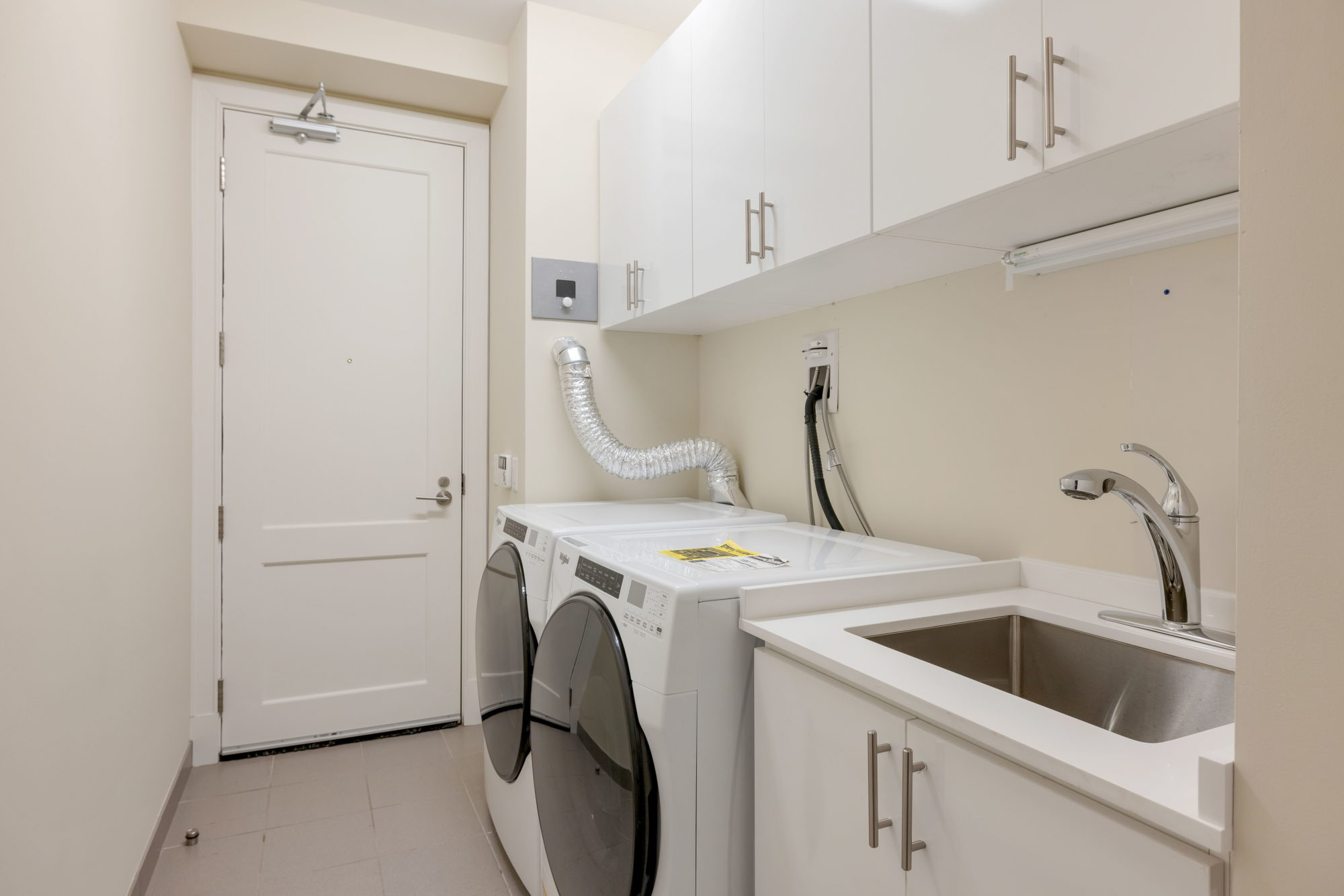 The laundry rooms has lots of storage, and the unit also has a storage locker downstairs. 