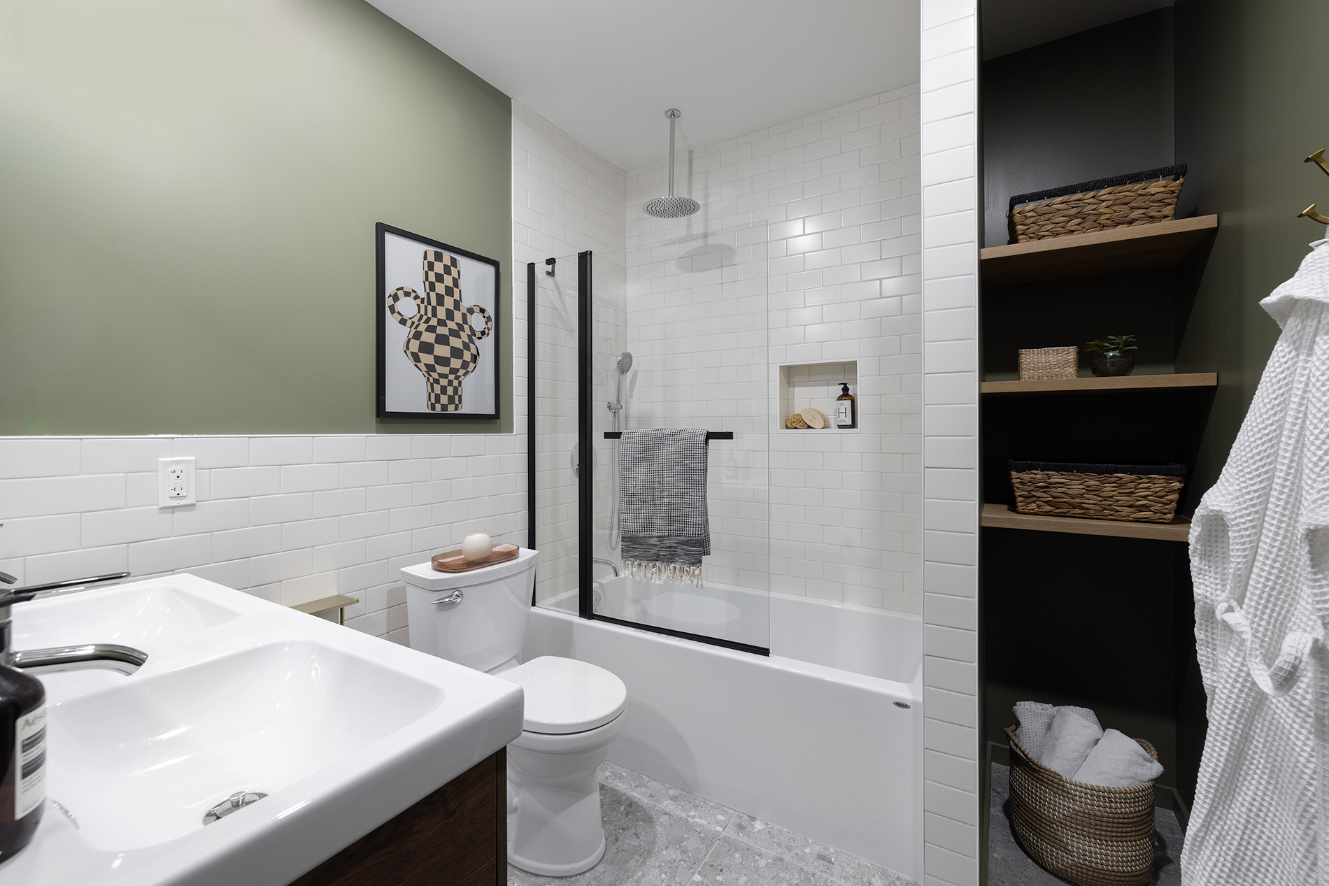 The bathroom is lined with subway tiles and plenty of storage. 