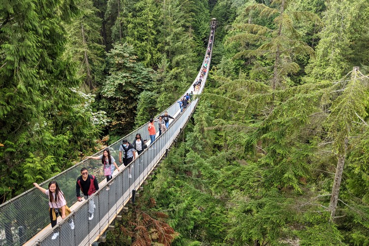 people walking across Capilano Suspension Bridge in North Vancouver BC