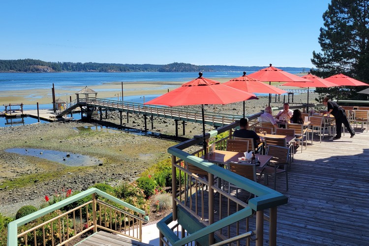 View of the Painter's Lodge patio seating during the day at low tide