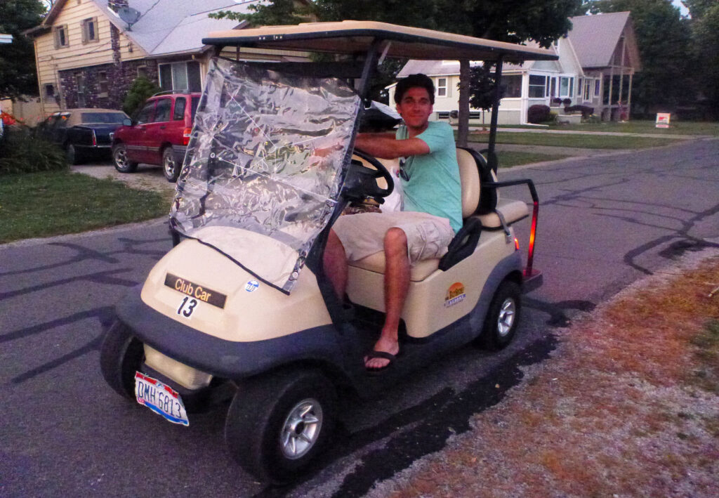 Justin in a golf cart