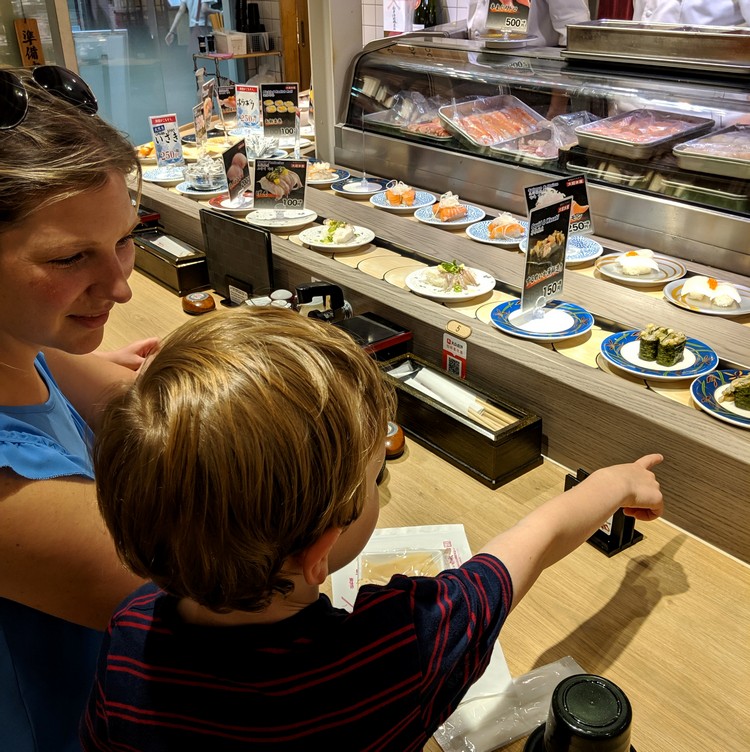 Conveyor belt sushi restaurant in Kyoto tourist area. Beginners Guide to Food in Japan for first time visitors