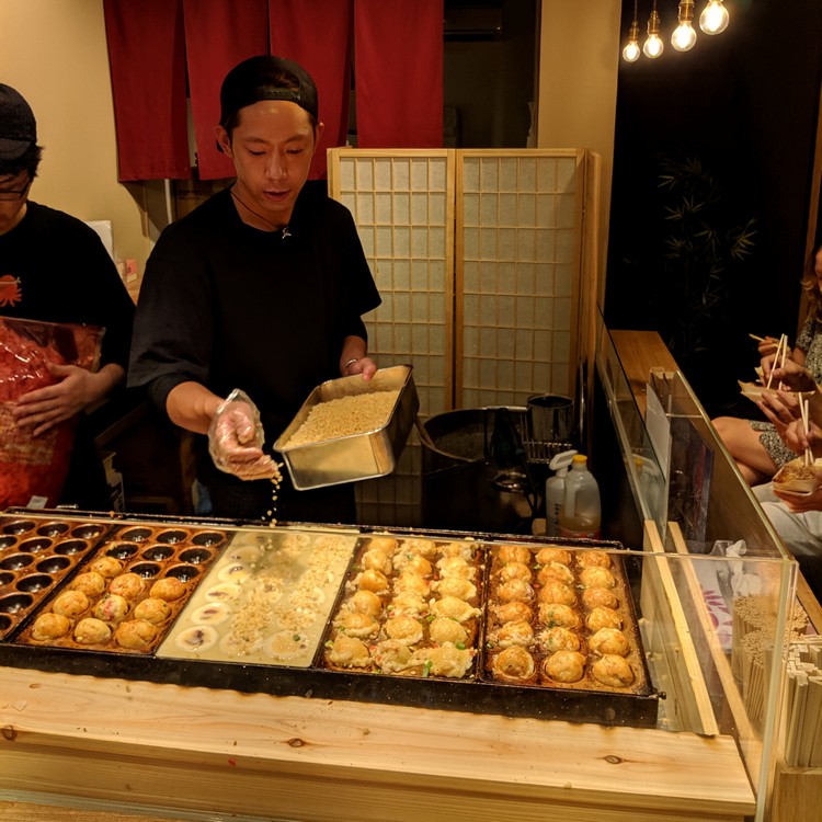 takoyaki shop in Nishiki Market in Kyoto. Must try Japanese food for tourist and first time visitors to Japan