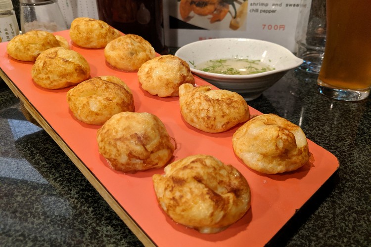 Takoyaki platter served plain with a light vinegar dipping sauce on the side. Japanese restaurant in Kobe