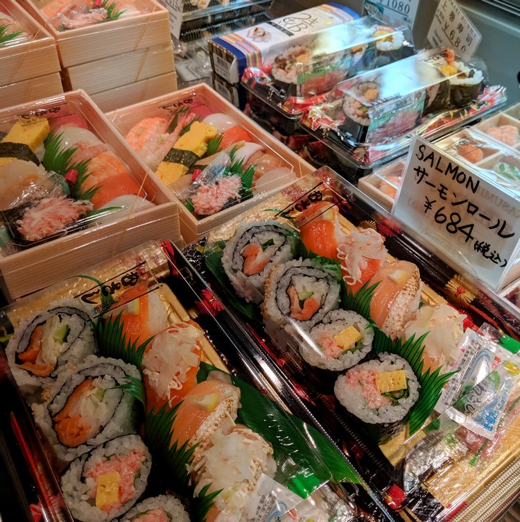 Variety of prepackaged sushi rolls and nigiri combos at the Kyoto train station. Beginners guide to Japanese food in Japan