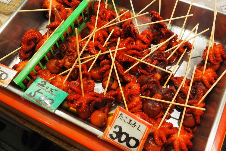 The popular red octopus on a stick at the popular Kyoto market, Nishiki Market interesting food to try in Kyoto