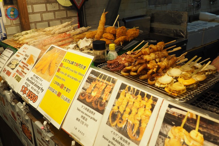 yakitori food vendor at Nishiki Market in Kyoto. Beginners guide to food in Japan for tourists